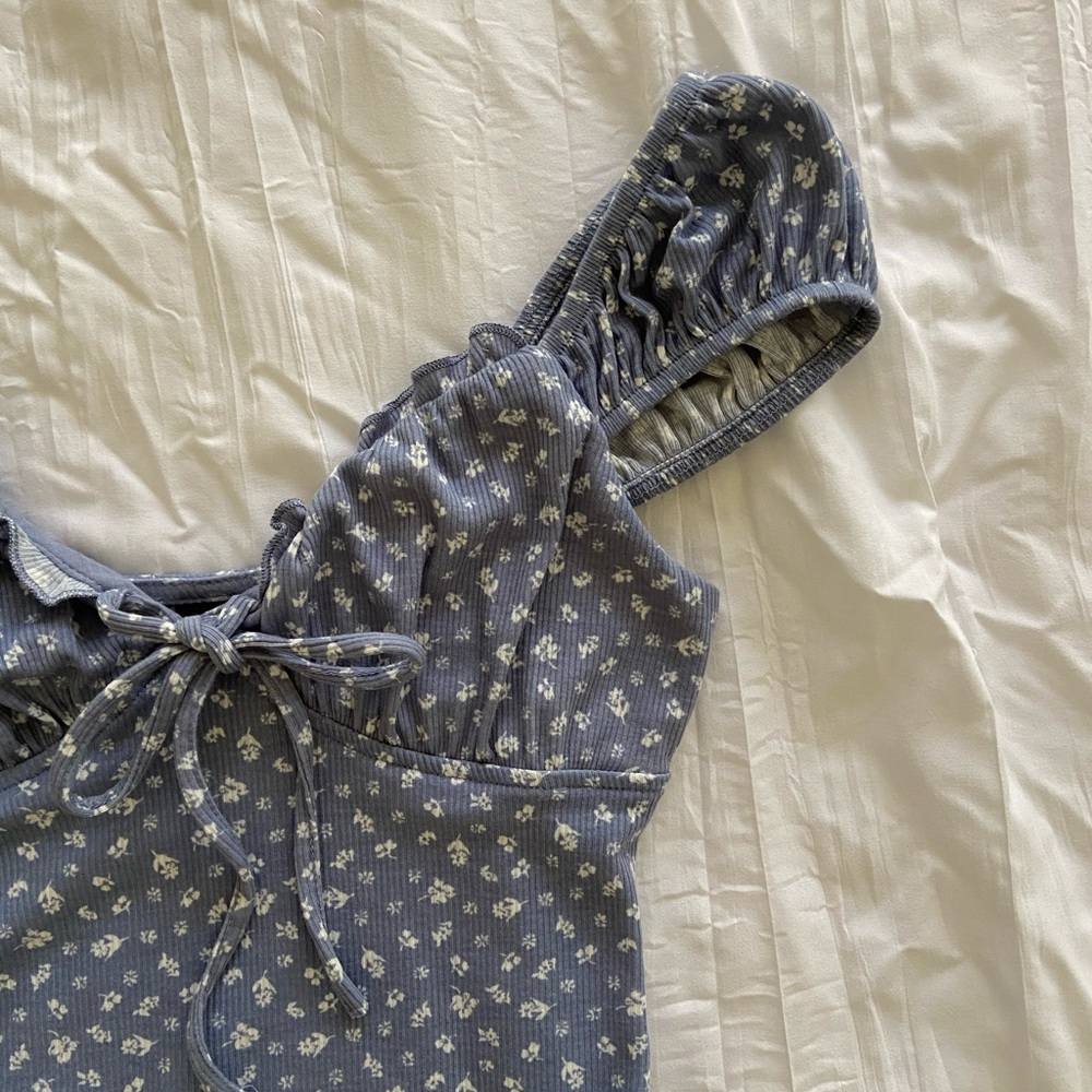 Blue floral bodysuit with cap sleeves and sweetheart neckline